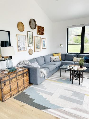 a living room with a blue couch and a table at Black Barn Ranch 25 Acres Wpool Near Downtown in San Luis Obispo