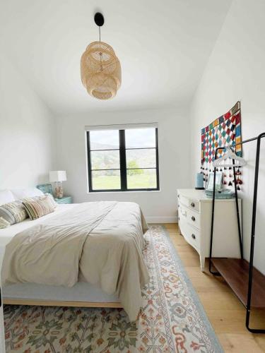 a bedroom with a bed and a dresser and a window at Black Barn Ranch 25 Acres Wpool Near Downtown in San Luis Obispo