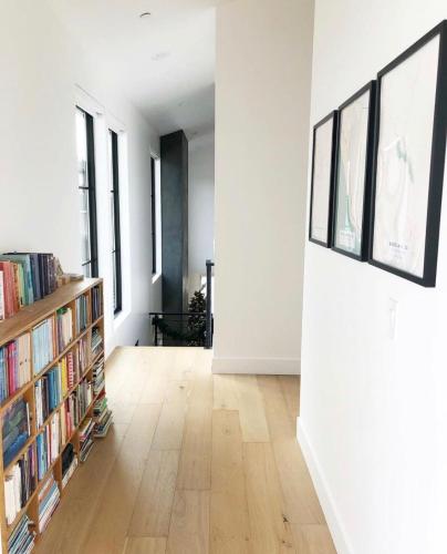 a room with white walls and a book shelf with books at Black Barn Ranch 25 Acres Wpool Near Downtown in San Luis Obispo