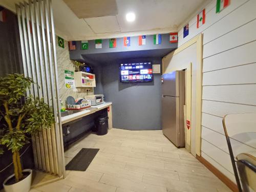 a hallway of a hospital with a sink and a counter at Travelogue Guest House in Kuala Lumpur