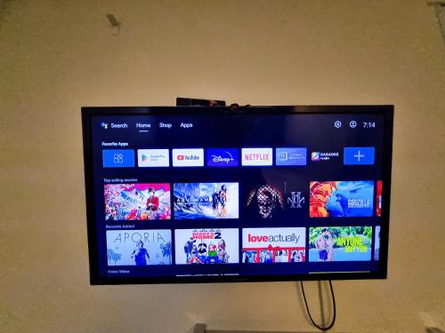 a flat screen tv hanging on a wall at Travelogue Guest House in Kuala Lumpur
