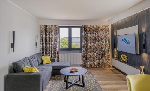 a living room with a couch and a table at Apartament w Cieplicach Elegant in Jelenia Góra
