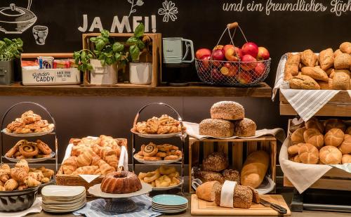 a bakery with different types of bread and pastries at Motel One Karlsruhe in Karlsruhe