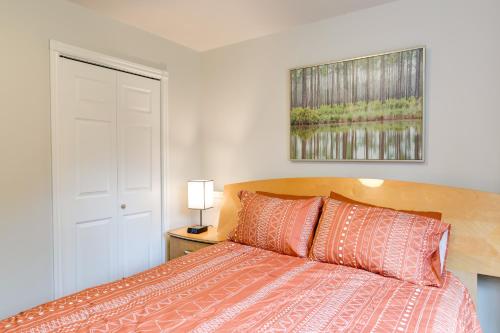 a bedroom with a bed with orange pillows at 6 Mi to Dtwn Bright and Airy Anchorage Getaway! in Anchorage