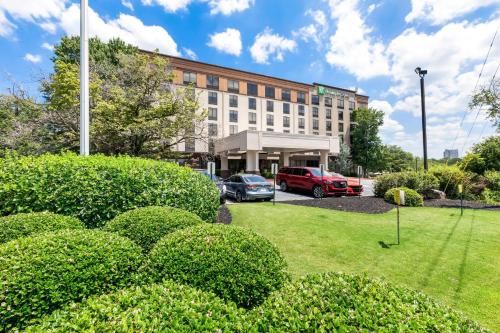 a building with cars parked in a parking lot at Holiday Inn Express Atlanta Galleria-Ballpark Area by IHG in Atlanta