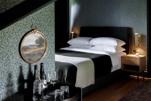 a bedroom with a bed with a mirror on the wall at Dvele Inn in St. John's