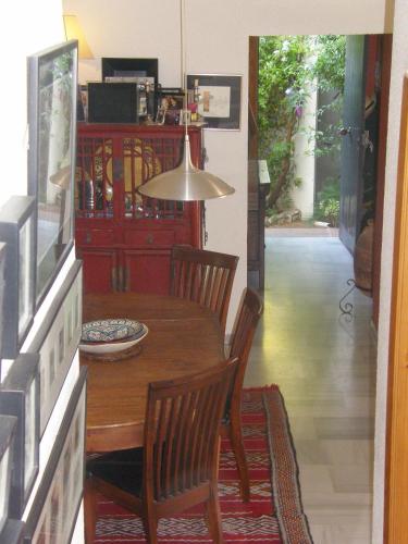 a dining room with a wooden table and chairs at El Descanso - SilHouse Nerja in Nerja