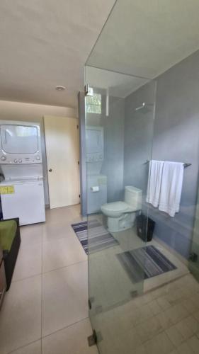 a bathroom with a toilet and a sink at Tranquilidad cerca del mar in Bucerías