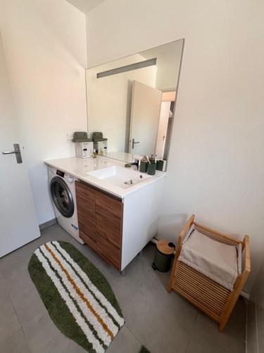 a bathroom with a sink and a mirror at Maison à Lacanau Océan in Lacanau-Océan