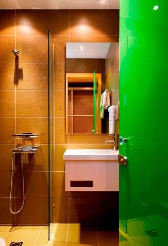 a bathroom with a sink and a glass shower at Astoria Hotel in Troulos