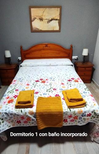 a bedroom with a bed with two towels on it at Los Álamos in Mérida