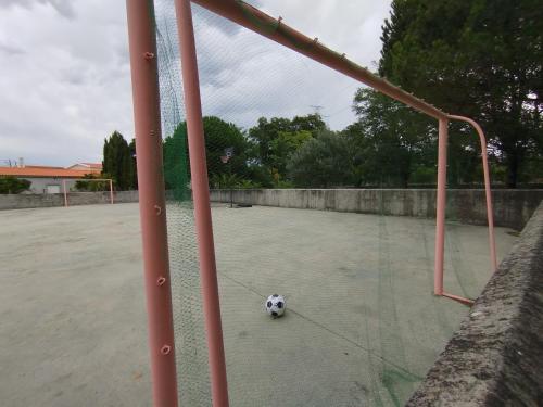 a soccer ball sitting on a soccer court at L'Arche de Jo in Santana