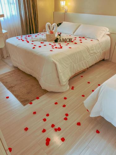 a bed with hearts on the floor in a bedroom at Pousada Cabanas Rota do Sol in Gramado