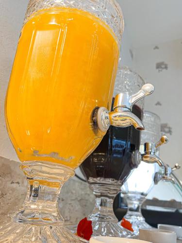 a glass of orange juice sitting on a table at Pousada Cabanas Rota do Sol in Gramado