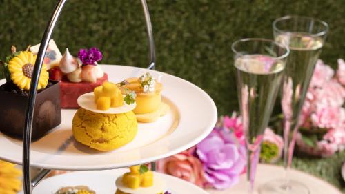a couple of plates of desserts and glasses of champagne at InterContinental London - The O2 in London