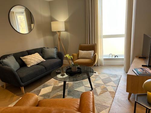 a living room with a couch and a table at Lambert House in Harrogate