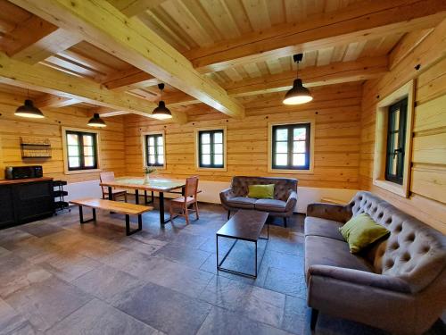 a living room with couches and a table in a cabin at Chalupa Vápenka - kapacita 10 osob in Stárkov