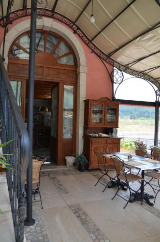 a patio with a table and chairs in a building at Agriturismo Corte Marani in Badia Calavena