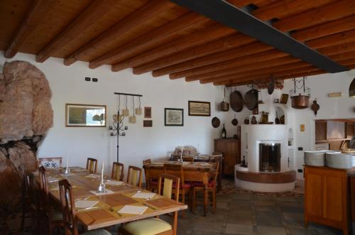 a kitchen and dining room with tables and a fireplace at Agriturismo Corte Marani in Badia Calavena