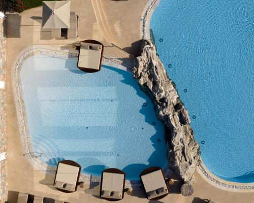 an overhead view of a swimming pool at a resort at Ikaros Beach, Luxury Resort & Spa - Adults Only in Malia