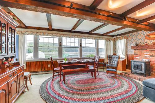 a living room with a table and chairs and a fireplace at Canandaigua Lakefront Gem with Dock and Boat Slip in Naples