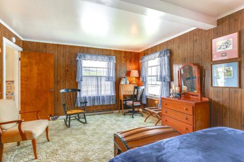 a bedroom with wood paneled walls and a bed and a dresser at Canandaigua Lakefront Gem with Dock and Boat Slip in Naples