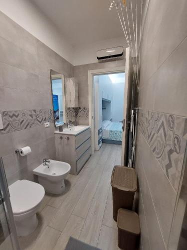a bathroom with a toilet and a sink and a tub at CASA VACANZE NANA' VIESTE in Vieste