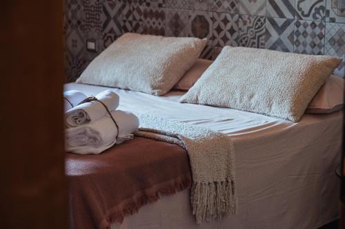 a bed with a teddy bear laying on it at Casale Sciarra in Anagni