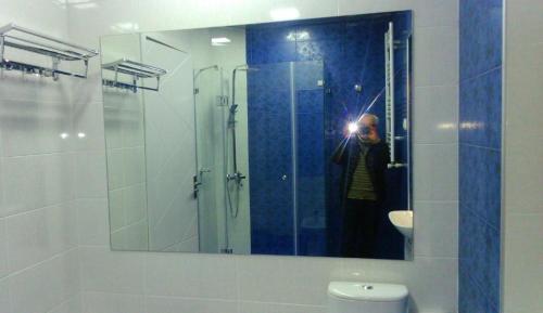 a person taking a picture in a bathroom mirror at Hotel Lilo near Airport in Tbilisi City