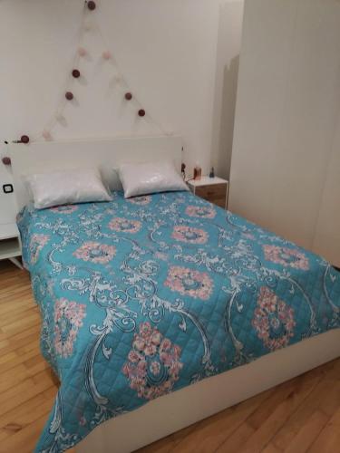 Un dormitorio con una cama con una manta azul. en Charmante petite maison à 15 min de Paris, en Villemomble
