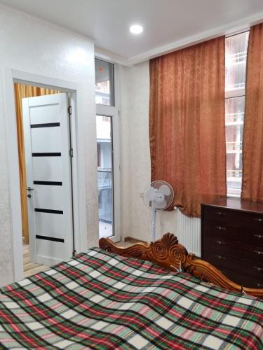 a bedroom with a bed and a dresser and a window at Black Sea Line in Gonio