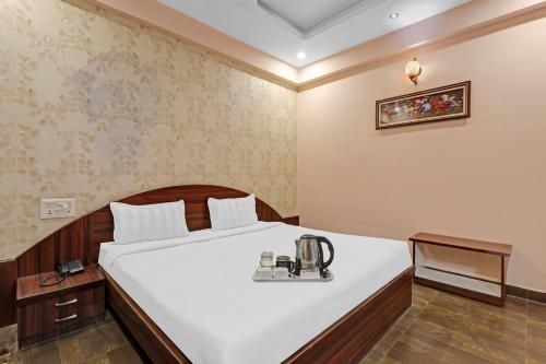 a bedroom with a bed with a sewing machine on it at Super Capital O Townhouse Govinda Royal in Kānpur
