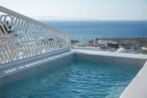 a swimming pool with a view of the ocean at La Madeleine Oia in Oia
