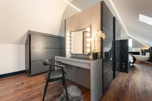 a room with a desk with a mirror and a chair at Samana Vayu in Poole