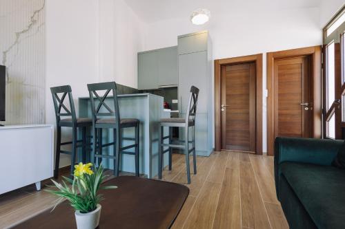 a kitchen and living room with a table and chairs at Barba Apartments in Ulcinj