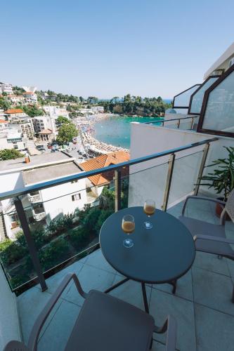 a balcony with a table and chairs and a view at Barba Apartments in Ulcinj