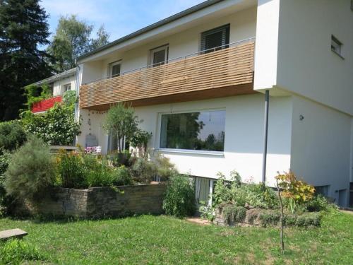 a house with a deck on the side of it at Zentrales 2-Zimmer Apartment in Tübingen