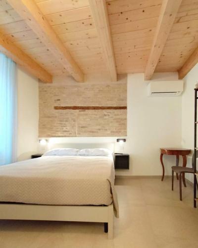 a bedroom with a bed and a wooden ceiling at Il Punto Fermo in Fermo