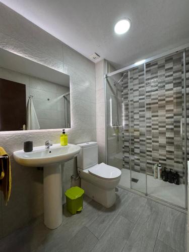 a bathroom with a toilet and a sink and a shower at Home San Jeronimo in Granada