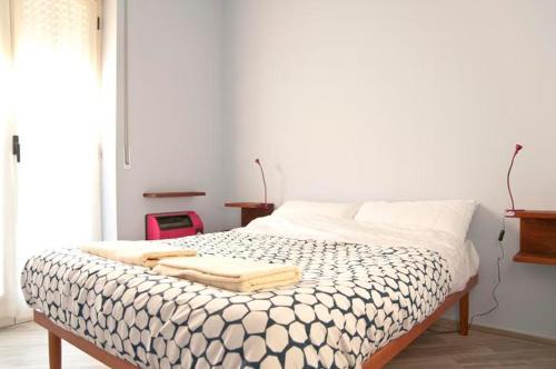 a bed with two towels on it in a room at Blueberry Rooms in La Morra