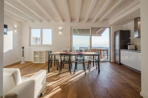 a kitchen and dining room with a table and chairs at Casanova Bluelife in Trieste