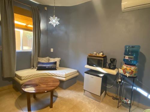 a small room with a bed and a table at Hotel Luna Loreto in Loreto