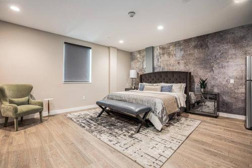 a bedroom with a large bed and a chair at Private Room, Kitchen & Bath 1 in Bradenton