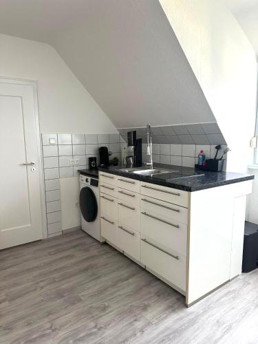 a kitchen with a sink and a washing machine at Apartment W32 in Friedrichshafen