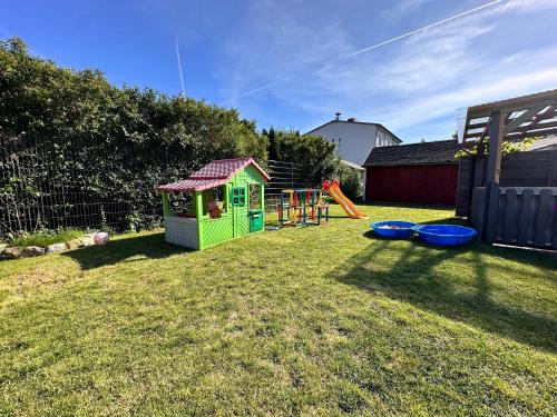 a backyard with a play set and a playground at Ost See Blick Ferienwohnung Nr1 Baabe in Baabe