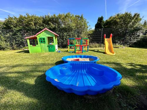 a playground with a blue play equipment in the grass at Ost See Blick Ferienwohnung Nr1 Baabe in Baabe