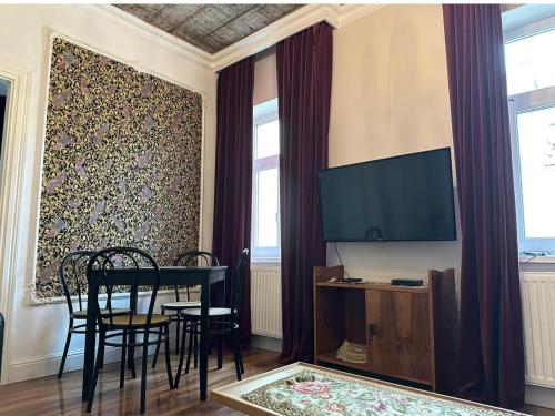 a living room with a table and chairs and a tv at Crystal Apartament in Lublin