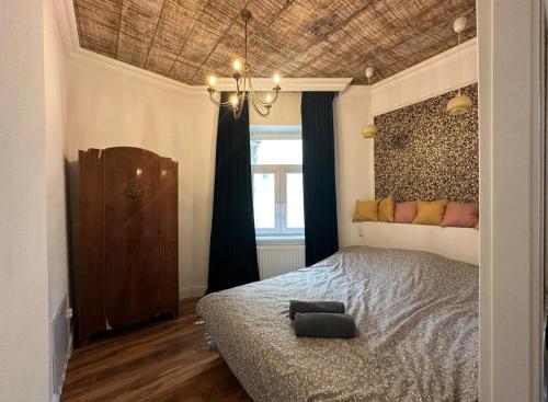 a bedroom with a bed and a chandelier at Crystal Apartament in Lublin