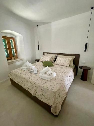 a bedroom with a bed with two towels on it at Old town Pjaca Makarska in Makarska