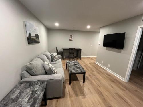 a living room with a couch and a table at Aksarben Area-Near I80 & UNO in Omaha